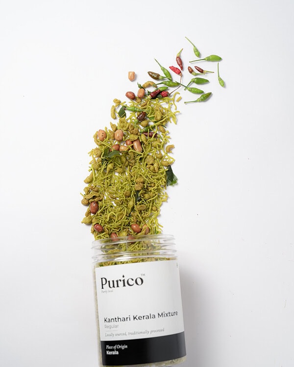 Kanthari Kerala mixture jar with ingredients bursting upward