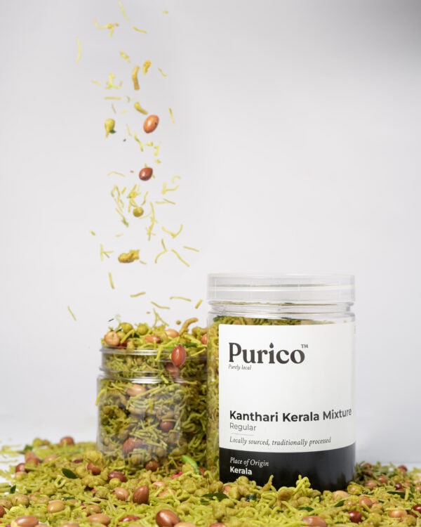 Kanthari Kerala mixture with ingredients falling into jar